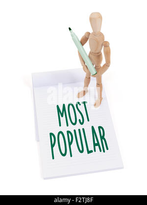 Hölzerne Puppe schreiben in einem Scrapbook - beliebteste Stockfoto