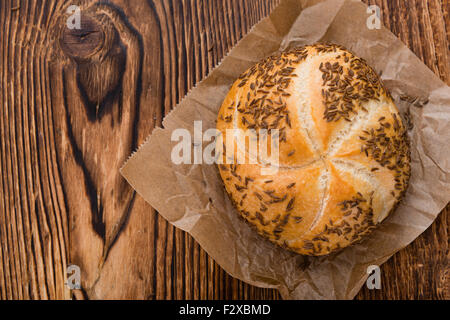 Frisch gebackene Brötchen (mit Kümmel) auf rustikalen hölzernen Hintergrund Stockfoto