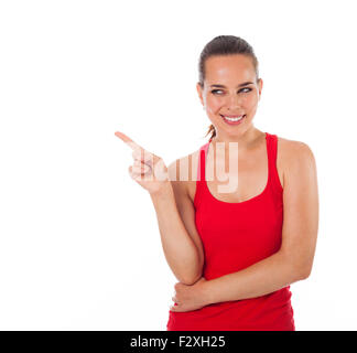 Junge lächelnde Frau, die etwas mit dem Finger, Exemplar, isoliert auf weiss Stockfoto