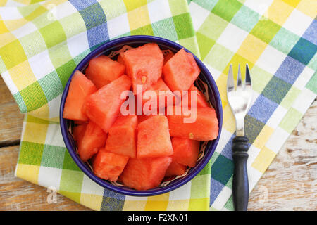 Wassermelone-Würfel in Schüssel auf kariertem Stoff Stockfoto