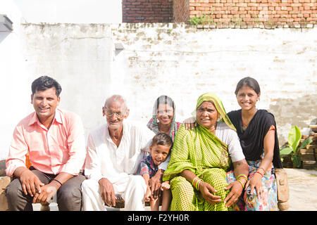 indische Gruppe Massen ländlichen Dorfbewohner Familie sitzt Hause Charpai Stockfoto
