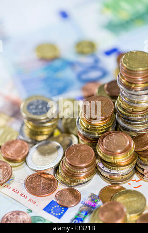 Euro-Münzen (auf Banknoten) als detaillierte Nahaufnahme gestapelt Stockfoto