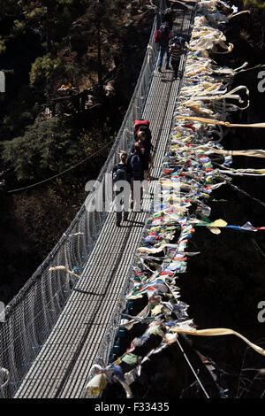 Reisende auf Stahl Kabel Hängebrücke über den Dudhkoshi-Fluss-Nepal Stockfoto