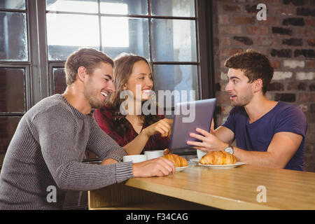 Lächelnden Freunde zeigen und mit Blick auf tablet Stockfoto