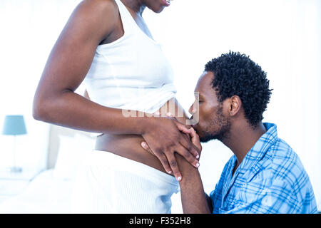 Zärtlich küssen Bauch seiner schwangeren Frau Mann Stockfoto