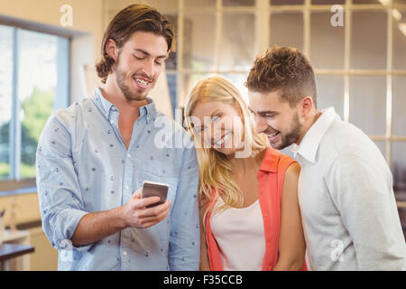 Gut aussehend Geschäftsmann zeigen etwas auf Smartphone an Kollegen Stockfoto