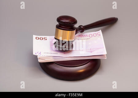 Hammer und Euro-Banknoten auf grau isoliert zu beurteilen Stockfoto