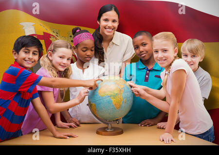 Zusammengesetztes Bild der niedlichen Schüler und Lehrer im Globe in Bibliothek suchen Stockfoto