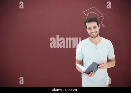 Zusammengesetztes Bild des Schülers Buch hält Stockfoto