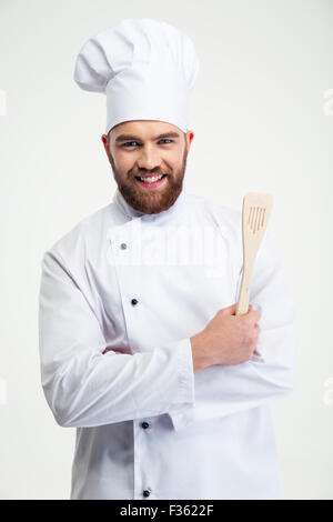 Porträt einer lächelnden Chef-Koch holding Löffel isoliert auf weißem Hintergrund Stockfoto