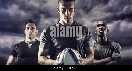 Zusammengesetztes Bild des nachdenklichen Rugby-Spieler mit ball Stockfoto