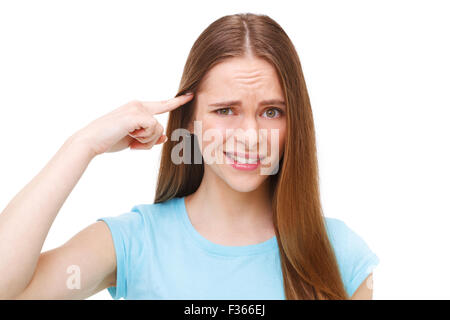 Bist du verrückt? Junge schöne Frau gestikulieren Finger gegen ihren Tempel. Isoliert auf weiss. Stockfoto