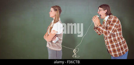 Zusammengesetztes Bild von geeky Hipster mit Schnur-Telefon Stockfoto
