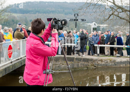 TV Kamera Crew (weiblich hinter der Linse) Dreharbeiten Menschen auf 2012 Sport Relief Event - Bingley fünf steigen sperrt, Leeds-Liverpool-Kanal, England, GB, UK. Stockfoto