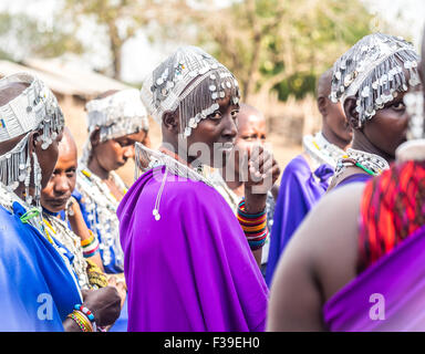 Massai-Frauen in traditionellen Outfits während der Zeremonie der Übergang in ein neues Zeitalter-Set für Jungen und Mädchen aus ihrer Gemeinde Stockfoto