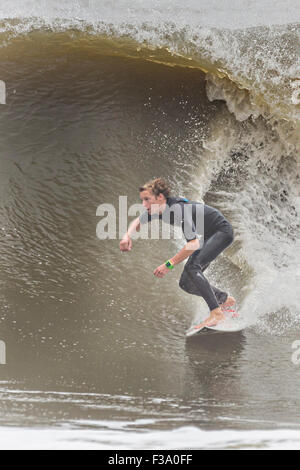 Eine Surfer reitet eine Welle an der Torheit Auswaschung im Laufe der Hurrikan Joaquin vor der Küste bringen hohe Brandung und Rip-Gezeiten zu den Stränden entlang der Küste South Carolinas 2. Oktober 2015 in Folly Beach, SC. Joaquin wird voraussichtlich die Carolinas zu vermeiden, sondern hat bereits hohe Brandung und Überschwemmungen verursacht. Stockfoto