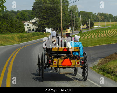 Amischen Familie fahren Pferd und Buggy entlang Country Road Lancaster County Pennsylvania USA Stockfoto