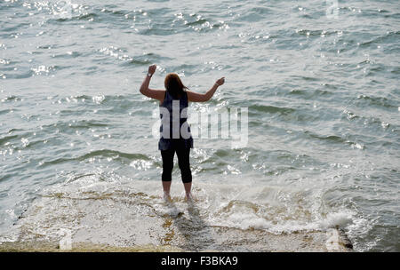 Brighton UK Sonntag, 4. Oktober 2015 - eine junge Frau genießt eine Paddel am Rande Meer, wie sie den schönen Spätsommer-Sonnenschein auf Brighton Seafront heute genießt. Stockfoto