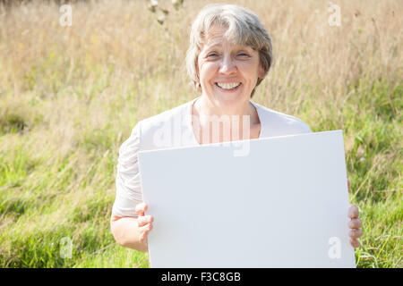 Alter Frau mit leeren weißen Schild Stockfoto