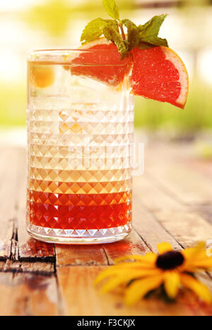 Glas kalte Limonade mit Minze und Grapefruit auf einem Holztisch hautnah Stockfoto