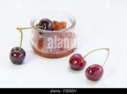 Fresh delicious dark red cherry fruits   and  marmalade isolated on white  background Stockfoto