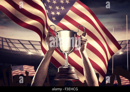 Zusammengesetztes Bild von erfolgreicher Rugbyspieler holding trophy Stockfoto