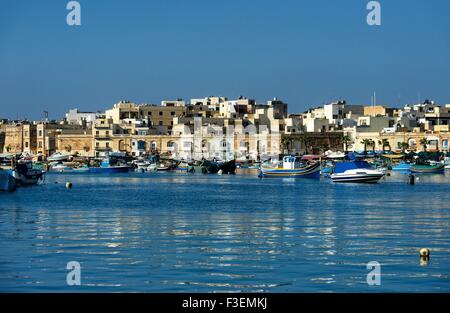 Traditionelle maltesische Fischerboote mit Spiegelbild im maltesischen Dorf MARSAXLOKK, MALTA Stockfoto