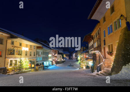 Malerische Winter Nacht Blick auf die mittelalterliche Stadt Gruyères, Schweiz. Es ist ein wichtiger touristischer Ort im oberen Tal des Flusses Saane und gibt seinen Namen dem berühmten Gruyere-Käse Stockfoto