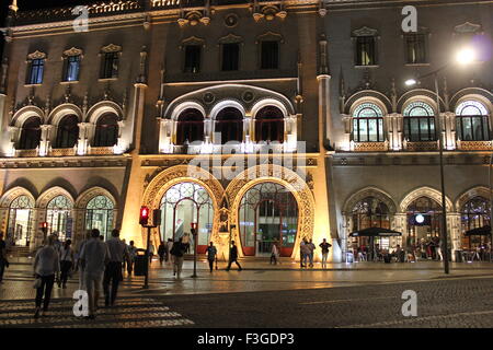 Lissabon, PORTUGAL - 23. Oktober 2014: Rossio-Bahnhof Haupteingang bei Nacht mit Passanten auf der Straße Stockfoto