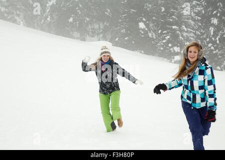 Junge Frauen spielen im Schnee, Sattelbergalm, Tirol, Österreich Stockfoto