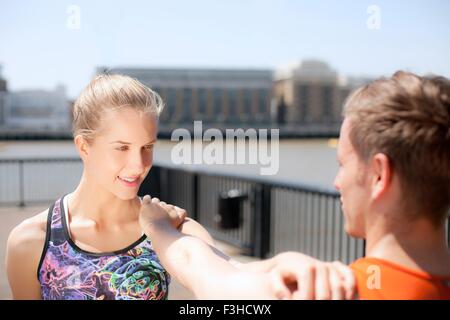 Läufer, die Dehnung am Flussufer, Wapping, London Stockfoto