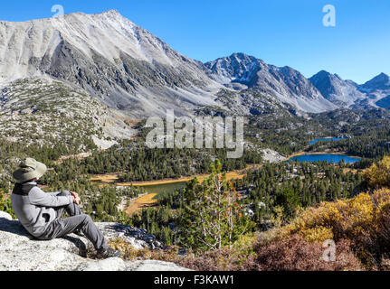 Wanderer am Aussichtspunkt neben der Mono Pass Trail entspannende sieht kleine Seen-Tal im Rock Creek Canyon in der östlichen Sierra Stockfoto