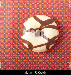 Donut mit Glasur auf bunten Retro-Hintergrund von oben Stockfoto