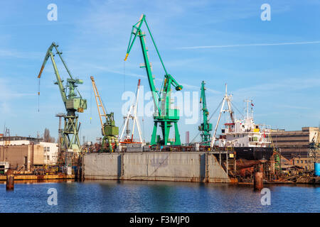 Ein Blick auf ein großes Schiff in Reparatur im Trockendock auf einer Werft. Stockfoto