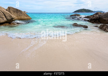 Schöne Natur des blauen Meeres Sand und weißen Wellen am kleinen Strand in der Nähe der Felsen im Sommer auf der Insel Koh Miang in Koh Similan Stockfoto