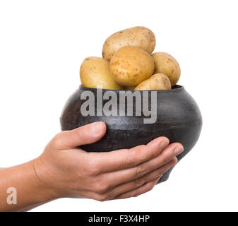 Gusseisen-Topf mit einer Kartoffel in den Händen Stockfoto