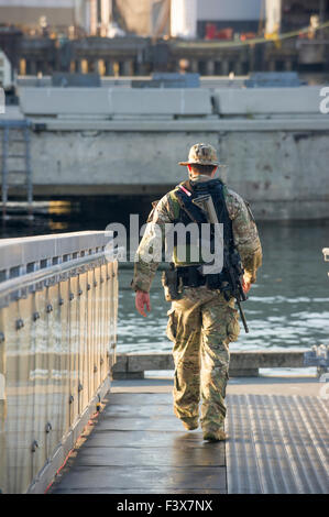 Canadian RCMP ERT Mitglied bewaffnet mit automatischen Waffe festgeschnallt zu sein wieder hinunter eine Rampe im Hafen von Vancouver, BC Stockfoto