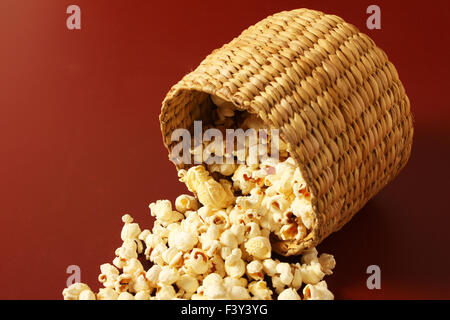 Popcorn in Schüssel Verbreitung auf rotem Grund Stockfoto