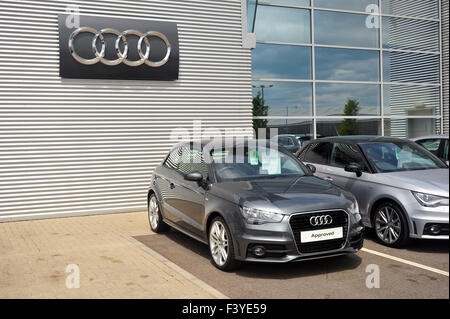 Ein grauer Audi A1 vor einem großen Audi-Logo bei einem Audi Händler in Gloucestershire geparkt. Stockfoto