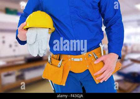 Zusammengesetztes Bild von Handyman holding Helm Stockfoto