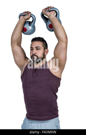 Muskuläre ernster Mann heben kettlebells Stockfoto