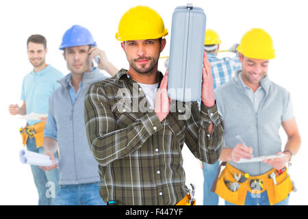 Zusammengesetztes Bild der Mechaniker hält toolbox Stockfoto