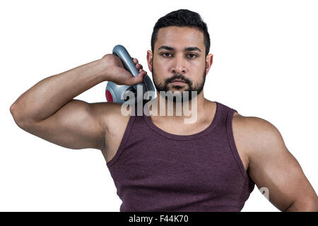 Muskuläre ernster Mann hält eine kettlebell Stockfoto