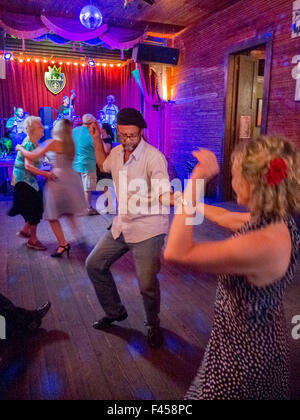 In Nordamerika, ein jazz-Club auf Frenchmen Street in New Orleans, ein glückliches Paar tanzt um die Band. Beachten Sie ältere Frauen tanzen zusammen auf der linken Seite. Stockfoto