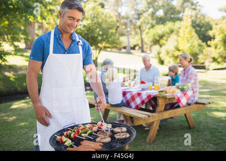 Glücklicher Mann Grill für seine Familie zu tun Stockfoto