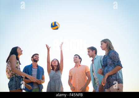 Glückliche Freunde werfen volleyball Stockfoto