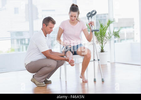 Arzt untersucht seinen Patienten Knien Stockfoto