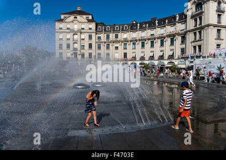 Kinder spielen im Wasser-Brunnen, Karlsplatz, München, Oberbayern, Deutschland, Europa. Stockfoto