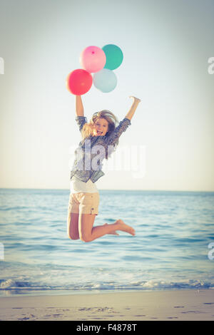 Happy young woman jumping together Stockfoto