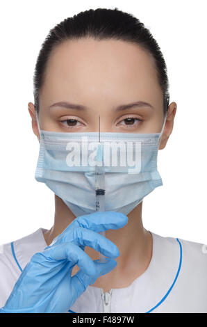 Arzt in einer Maske und Spritze Stockfoto